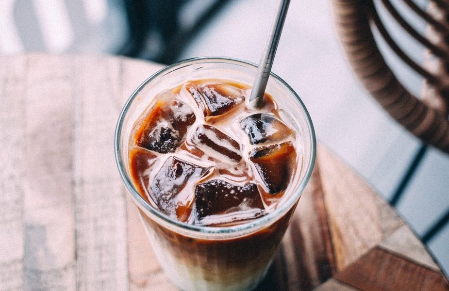 Glass with iced coffee and straw