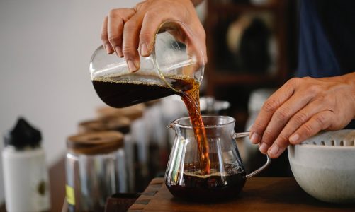 pouring coffee on another glass