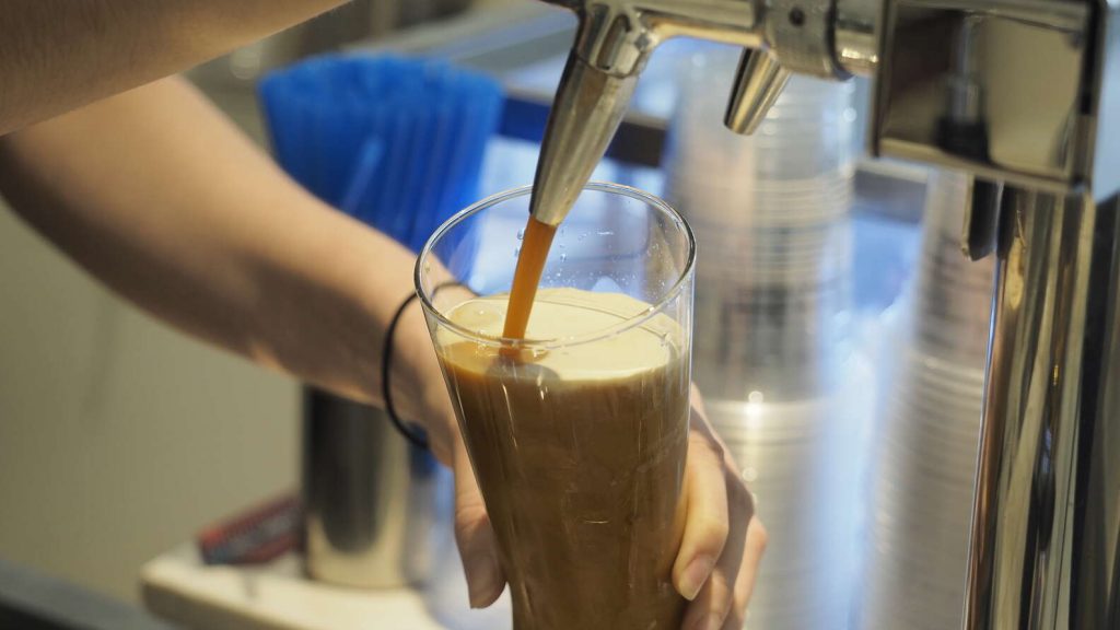 nitro cold brew coffee being poured from tap